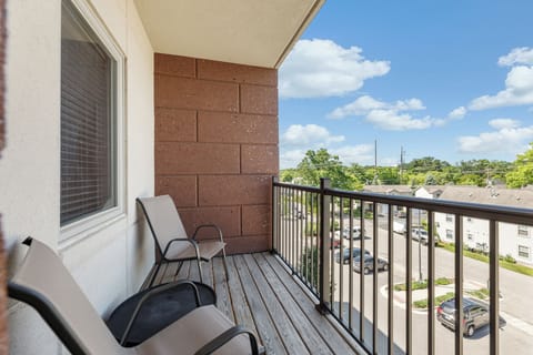 Private balcony w/ seating, perfect for morning coffee & city views under blue skies