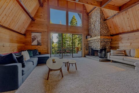 Living Room 1: 2 L-shaped couches, wood burning fireplace, river rock mantle, access to deck, main floor