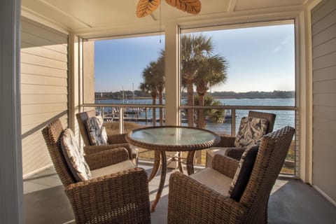 Sip your morning coffee while watching boats drift by on the tranquil waterfront from your private screened porch.