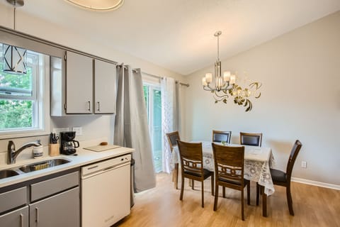 Dining area for 6 with an elegant chandelier, just steps away from the kitchen