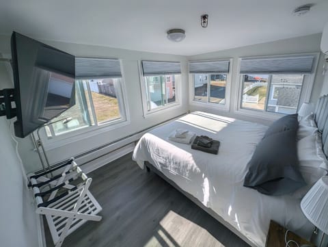 Rest easy in our cozy guest room, featuring a Queen-sized bed and dedicated bedside charging stations for all your devices.