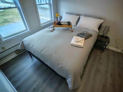 Rest easy in our cozy guest room, featuring a Queen-sized bed and dedicated bedside charging stations for all your devices.