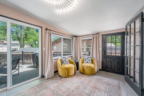 - Sun drenched sitting room with swivel velvet chairs and fun geometric pillows
- Floor to ceiling windows and sliding doors open to a peaceful fenced backyard
- Chic pendant light and soft drapes elevate this vibrant, airy retreat