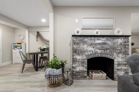 Charming fireplace area featuring a mantle and cozy decor, ideal for chilly evenings.