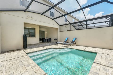 Private screened pool area with lounge chairs and outdoor dining space
