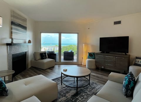 View of the water and beach from the comfortable living room wit - View of the water and beach from the comfortable living room with a smart  TV