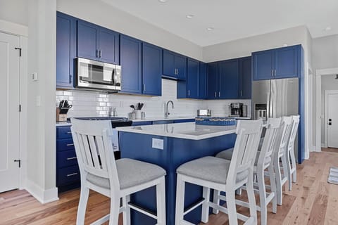 With seating for 5, the kitchen's center island is a popular gathering spot.