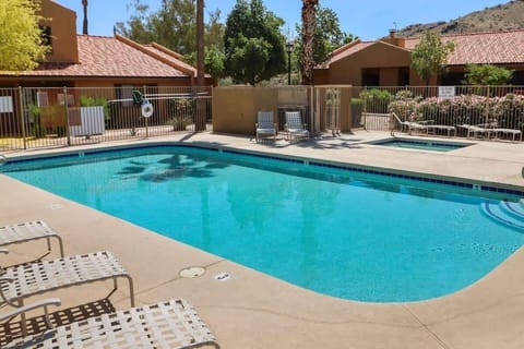 Sunlit pool ringed by lounge chairs—start with a refreshing swim, then sprawl poolside with the mountains in view. Gated deck and shady trees give you that easy, resort-style afternoon.