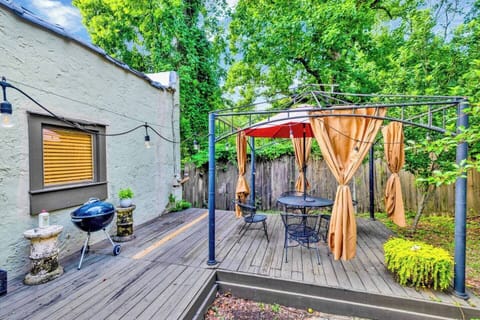 Grill out and dine al fresco beneath this dreamy canopy—strung lights, cozy curtains, and nature al