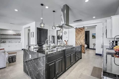 Fully Stocked Kitchen with seating for 5 people around the island.