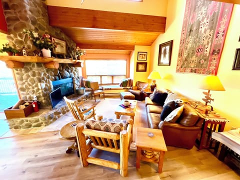 Comfortable great room with wood burning fireplace and window seat.