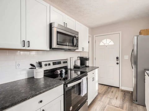 Experience cinematic elegance in this captivating living room, perfect for enjoying your favorite movies Fully equipped kitchen