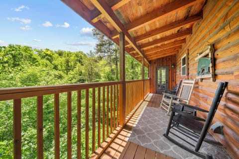 Soak in the treetop views from the deck with rocking chairs for two.