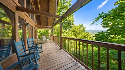 Multi-level deck with rocking chairs and sweeping valley panoramas.