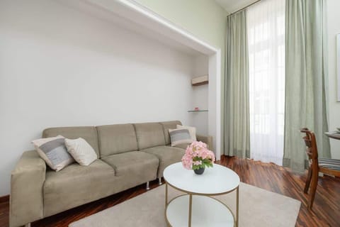 Cozy living room with a large sofa and modern TV, in warm, muted colors, creating a spacious corner for relaxation.