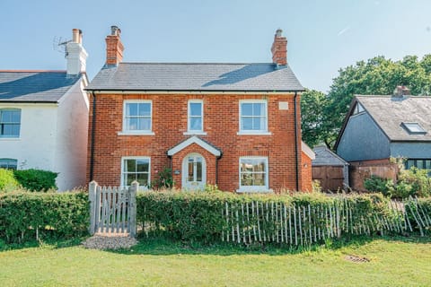 Classic red-brick cottage with forest-edge charm