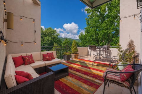 Relax on your private rooftop terrace with sweeping views of lush rolling hills and vibrant greenery—perfect for morning coffee or sunset cocktails under the open sky.
