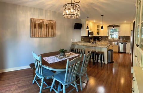 Table has a leaf and additional chairs.