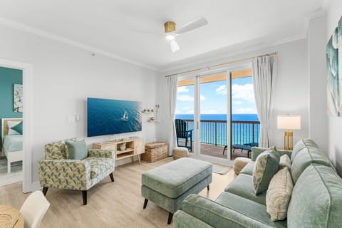 Bright living room with Gulf views, 65” Roku Smart TV, and a queen pull-out sofa—perfect for relaxing after beach days.