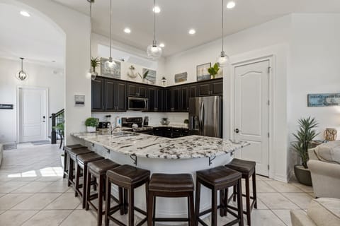 Cook and gather in this modern kitchen featuring beautiful finishes, a large island, and plenty of seating.
