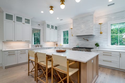 The kitchen's center island has seating for 3