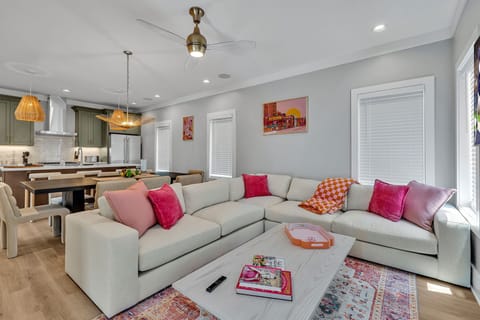 Unit 1 - 2nd Floor: Warm and inviting open-concept living space seamlessly flowing the designer furnished living room with the fully equipped kitchen and dining area.