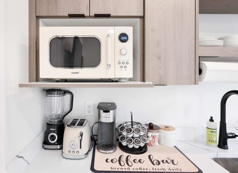Start your day right with our coffee bar, featuring a microwave, blender, toaster, and coffee maker, ensuring you have everything you need