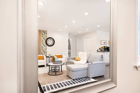 Stylish living room view reflected in the elegant wall mirror.