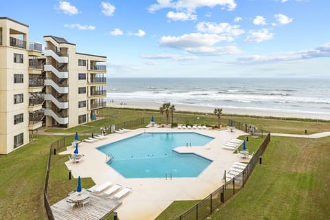 Oceanfront resort featuring a large swimming pool with beach access and balcony views of the Atlantic coastline.