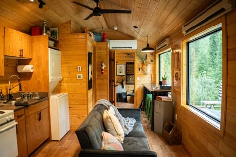 Interiors are cozy and spacious with large picture windows viewing the lush forest