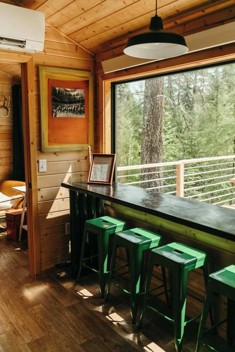 Custom dining table looks out at the beautiful forest and offers gorgeous natural light and private views.