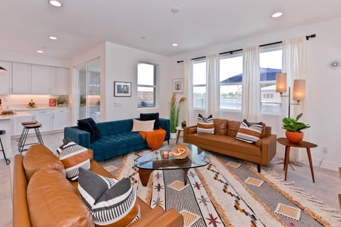 Unwind in stylish comfort in this spacious and sunlit living room. The perfect blend of mid-century modern and contemporary design creates a welcoming atmosphere for relaxation and entertainment.