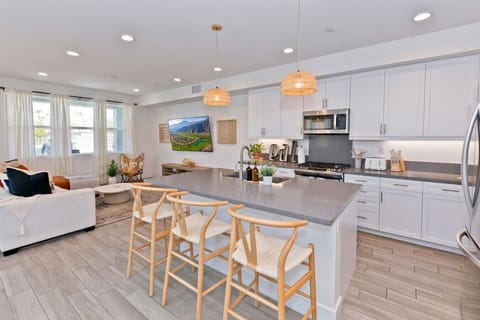 Gather around the stylish kitchen island for a casual meal, evening drinks, or a productive workday at the bar stools. Perfect for entertaining or a quiet night in.