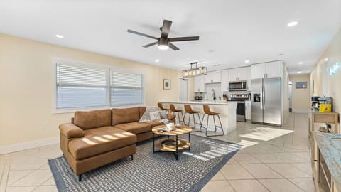 Cocoa Beach Living Room | Spacious open layout featuring a modern kitchen, comfy sectional, and easygoing coastal warmth.