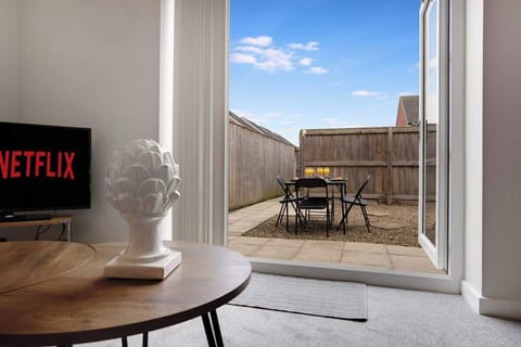 Whether you're enjoying a meal or relaxing indoors, this spacious living and dining area includes a Smart TV, seating for four, and a comfortable sofa bed.