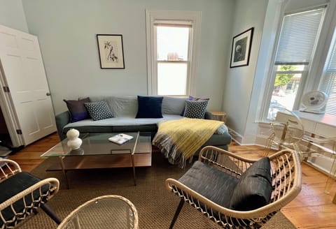 Living room with flat screen TV and desk overlooking North Street. 