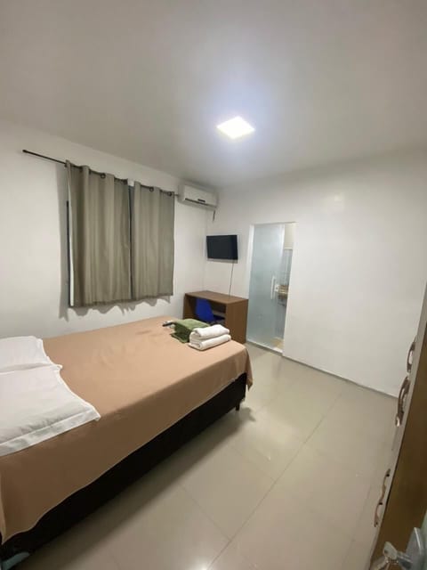 Economy Double Room | Desk, laptop workspace, blackout drapes, iron/ironing board