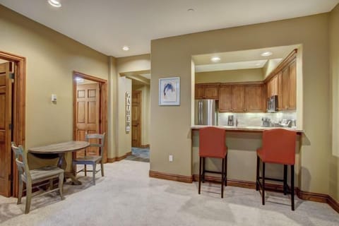 Bright and inviting entryway showcasing a small dining nook, complemented by warm, earthy tones.