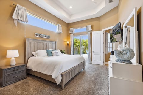 Master bedroom with a king-size bed and sliding doors leading straight to the backyard oasis!