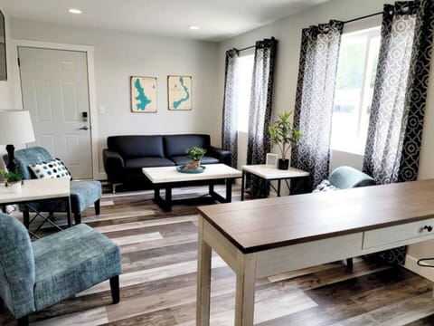 When standing in the kitchen, you will have 3 windows facing the west.  There are 3 chairs, a couch and smart tv in the living room. Directly out your entrance is the door leading to the roof top patio. 