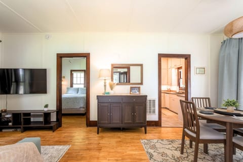 The Main Cottage dining room and living room, with access to main bedroom and kitchen