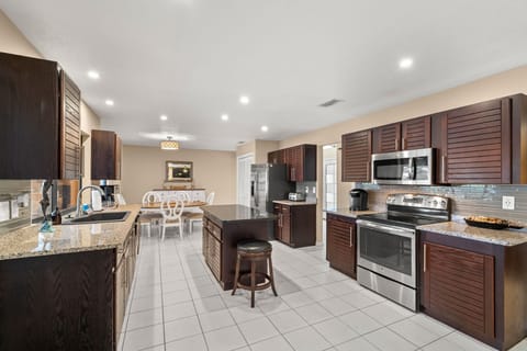 Chef's kitchen offers stainless steel appliances, granite countertops and a pantry