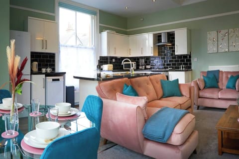 A generous and inviting space featuring a large, comfortable couch. Ideal for relaxation and socializing, with ample seating for gatherings and a cozy atmosphere.