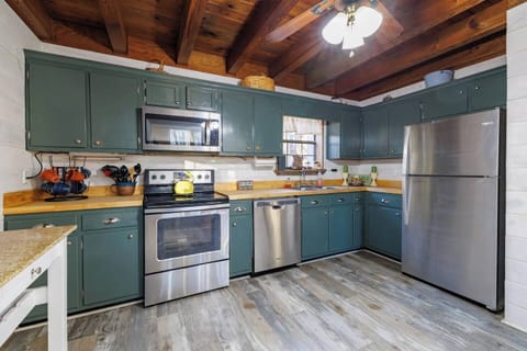 Fully equipped kitchen with modern appliances and ample prep space.