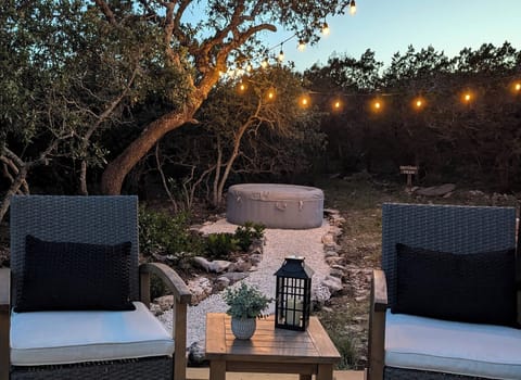 Relax in the soothing hot tub under the glow of the string lights.