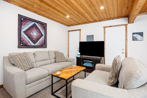 Relax in the cozy living room w/ plush couches, wood ceilings & a smart TV for easy streaming nights.