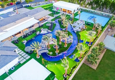 Get a full aerial perspective of the property’s showstopping lazy river, multiple water slides, and lush landscaping. This sweeping view captures the sheer scale and immersive design of your private resort paradise.