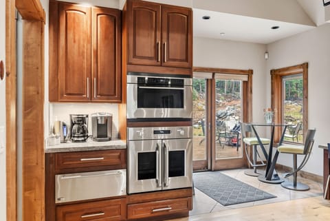 Prepare delicious meals in the fully-equipped kitchen outfitted with top-of-the-line stainless steel appliances and a large center island.