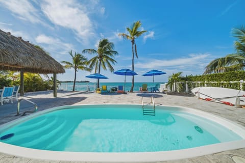 Heated (on request) oceanfront pool with tiki hut and unobstructed open water views at Mystic Waters in Marathon, FL.