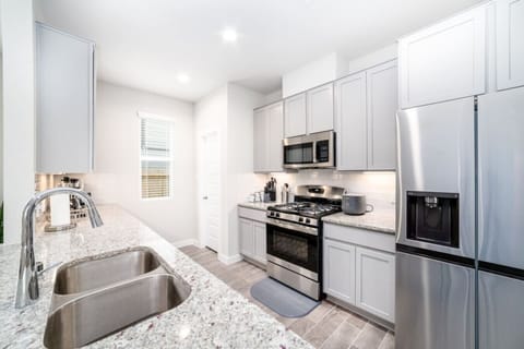 Modern kitchen with a sleek sink and top-of-the-line appliances for all your cooking needs.